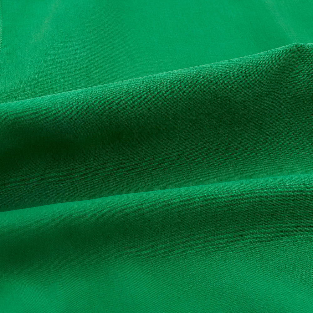 The Turnbull & Asser Green Silk Hyde Pyjamas Set features a long-sleeve button-up top with three pockets and modern fit elastic waistband pants in silk blend, both shown laid flat on a white background.
