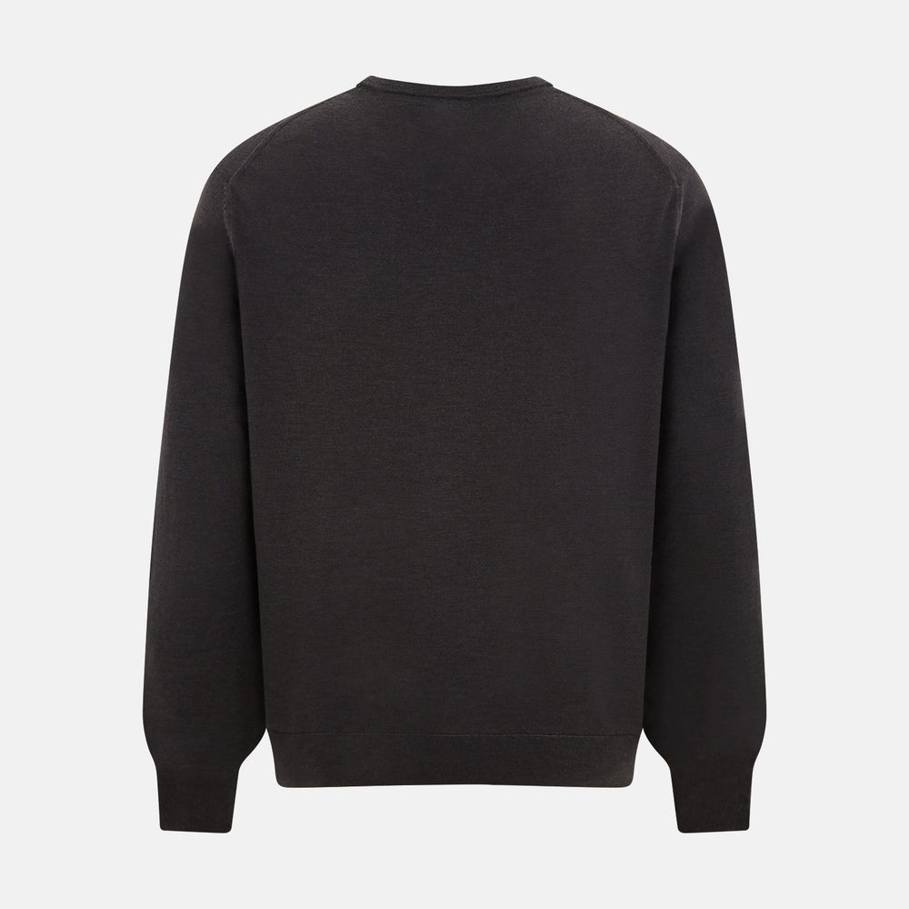 The Turnbull & Asser Charcoal Grey Fine Merino Round Neck Jumper for men features long sleeves, ribbed cuffs, hem, and collar. Displayed on a white background, this classic knitwear piece has a plain design with no visible logos or patterns.
