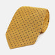 The Turnbull & Asser Navy and Yellow Micro Dot Silk Tie features evenly spaced dark blue micro dots on yellow silk, rolled and displayed on a white background—an elegant accessory for any occasion.