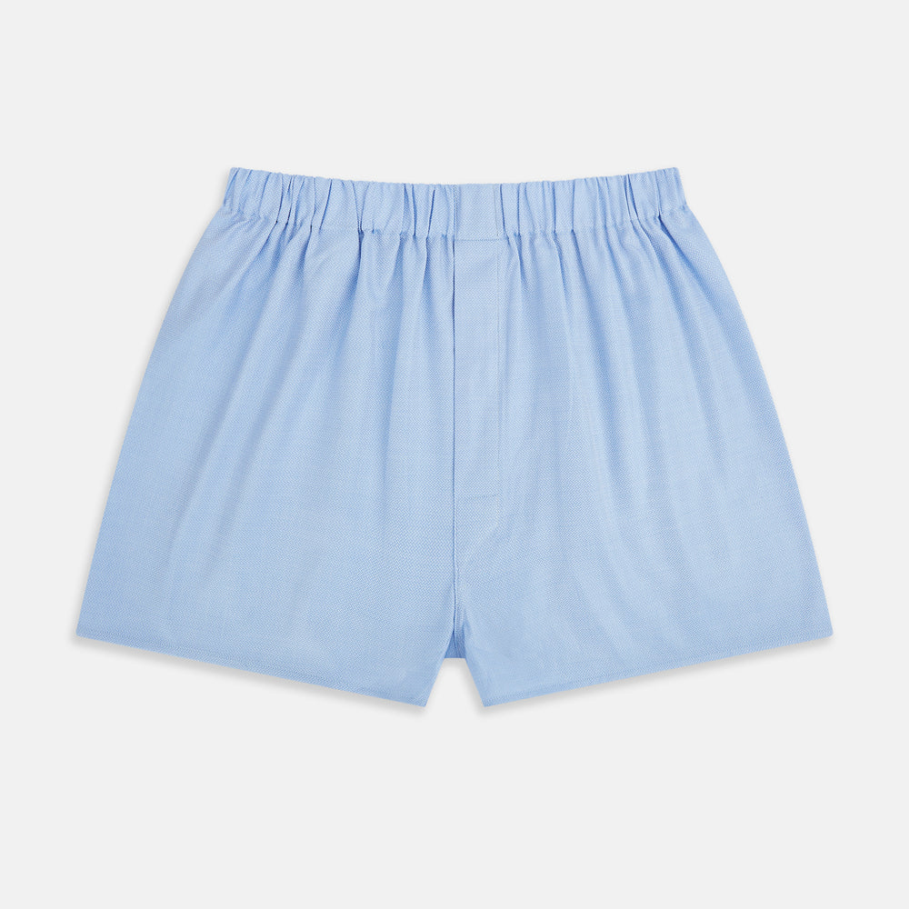 Plain Blue Godfrey Boxer Shorts by Turnbull & Asser, crafted from smooth Italian cotton. Featuring a light blue color and elastic waistband, these men's boxers are shown flat on a white background with a classic, pattern-free design.