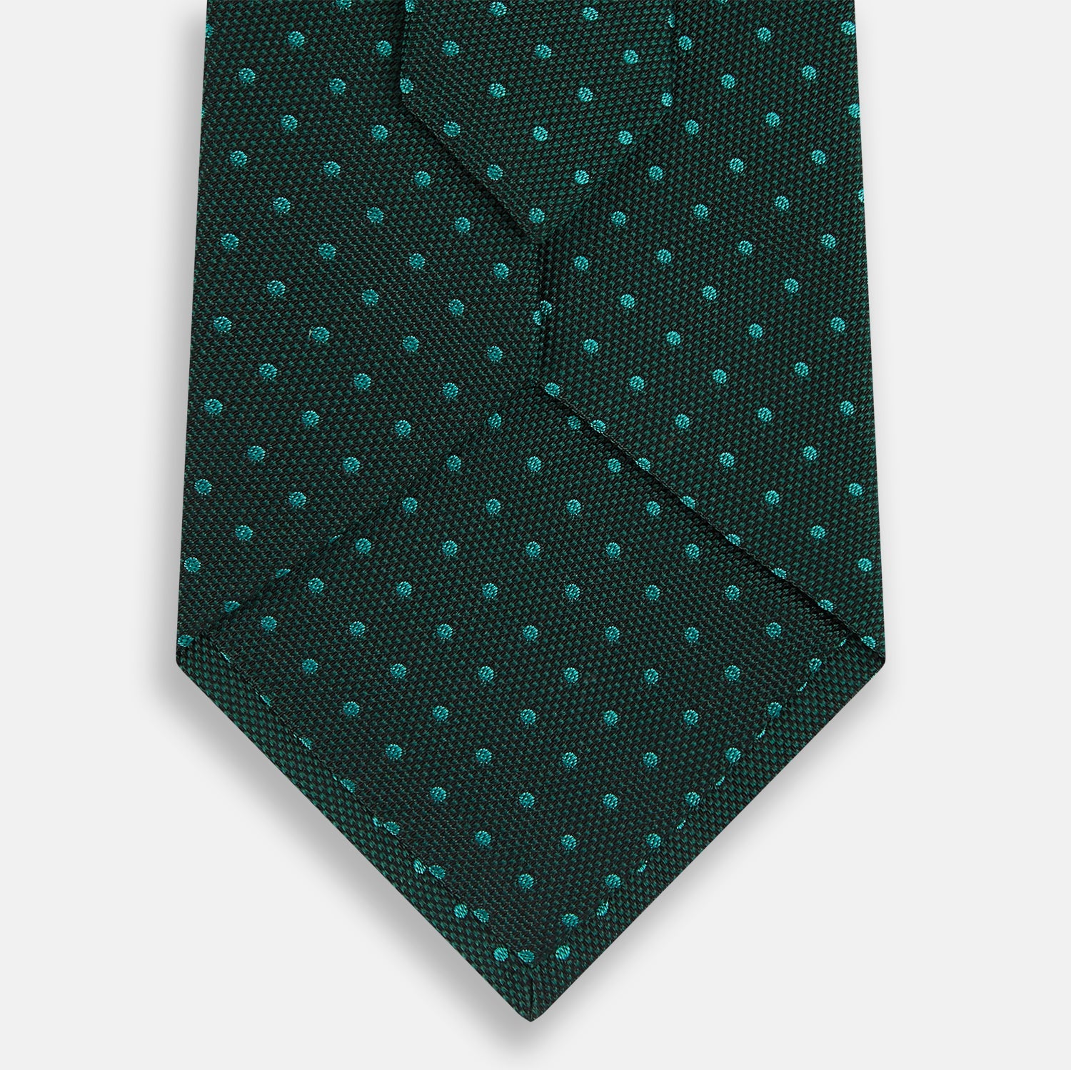 View 3 of product The Turnbull & Asser Dark Green Micro Dot Silk Tie features a refined pattern of light blue micro dots, making it the perfect accessory for any occasion.