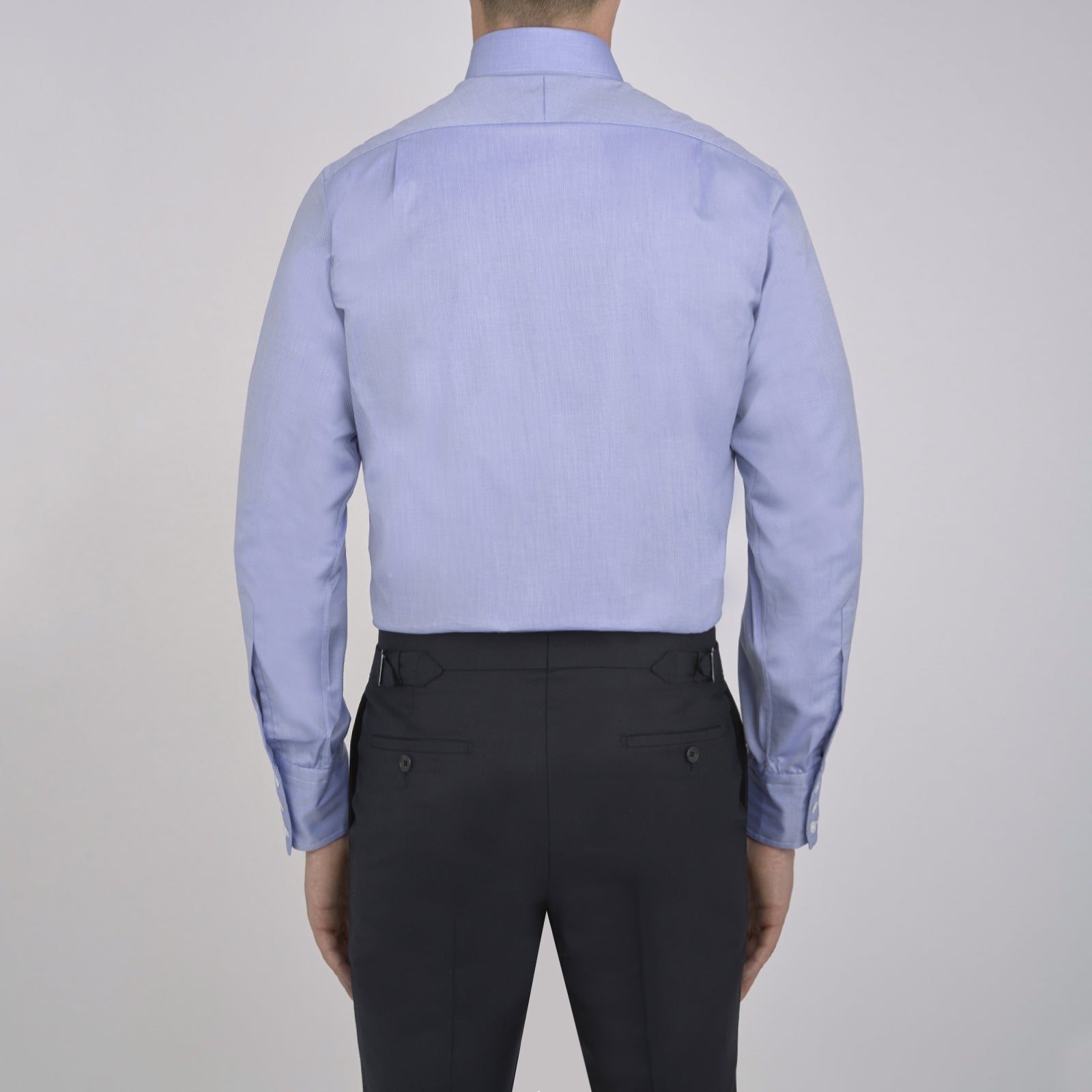 View 5 of product The Turnbull & Asser Blue Royal Oxford Cotton Shirt features a button-down collar, 3-button cuffs, and a visible brand label, shown neatly folded on a white background—ideal for pairing with a navy suit.