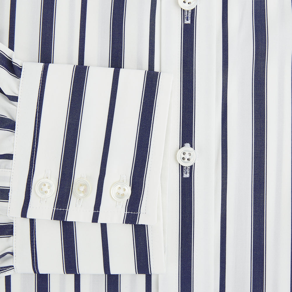 The Navy Double Stripe Mayfair Shirt by Turnbull & Asser features classic long sleeves, buttoned cuffs, a collar, and a slightly curved hem with timeless vertical navy and white stripes.