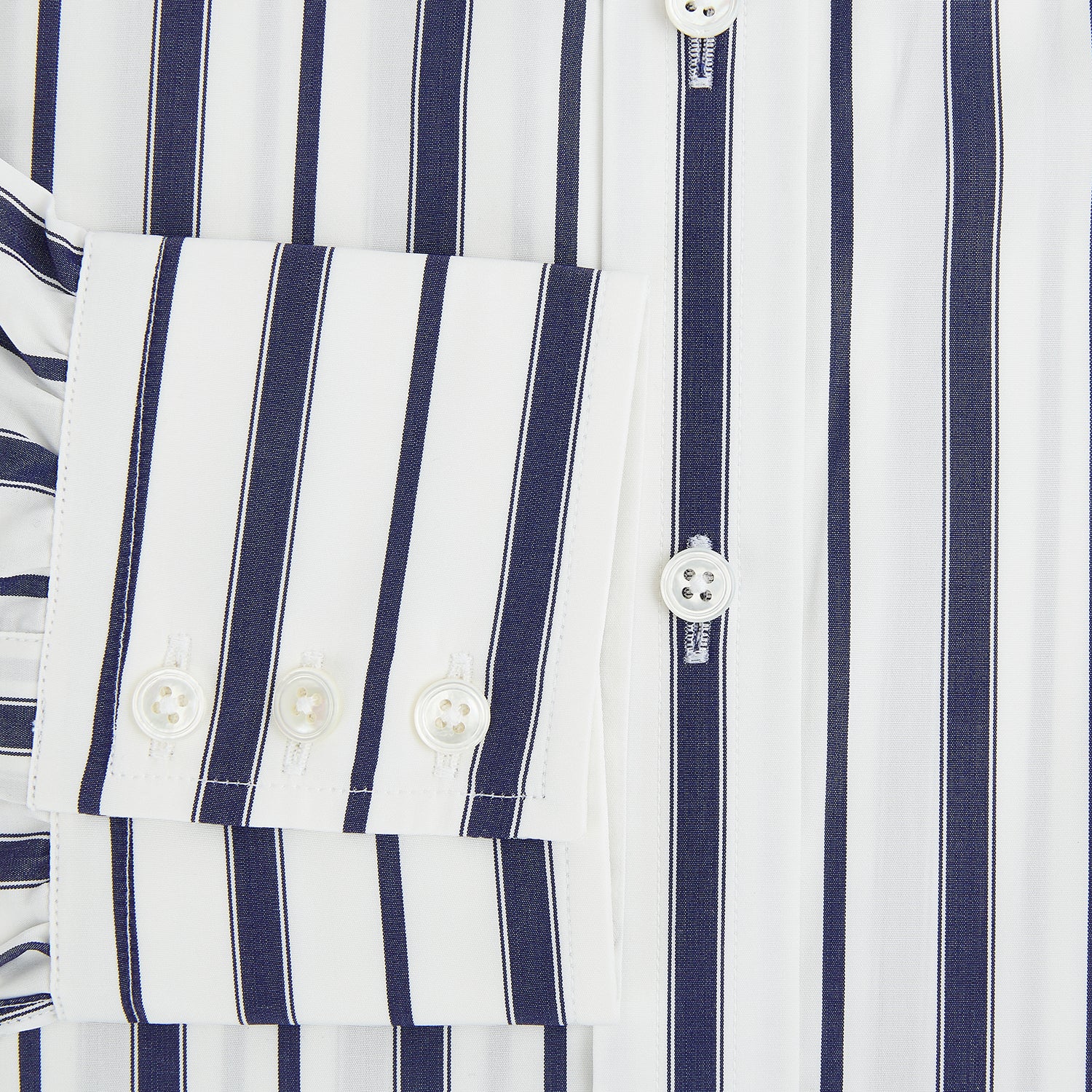 View 4 of product The Navy Double Stripe Mayfair Shirt by Turnbull & Asser features classic long sleeves, buttoned cuffs, a collar, and a slightly curved hem with timeless vertical navy and white stripes.