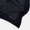 View 2 of product A Navy and Grey Stripe Silk Pocket Square by Turnbull & Asser, featuring hand-rolled edges and brand text in the corner. One corner is folded to show the reverse side.