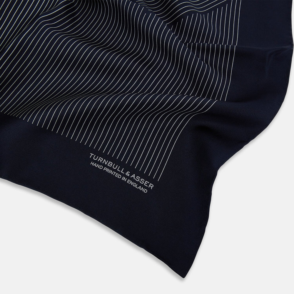 A Navy and Grey Stripe Silk Pocket Square by Turnbull & Asser, featuring hand-rolled edges and brand text in the corner. One corner is folded to show the reverse side.