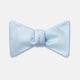 The Turnbull & Asser Pale Blue and White Houndstooth Silk Bow Tie features a refined textured pattern, making it an elegant formalwear accessory against a crisp white background.
