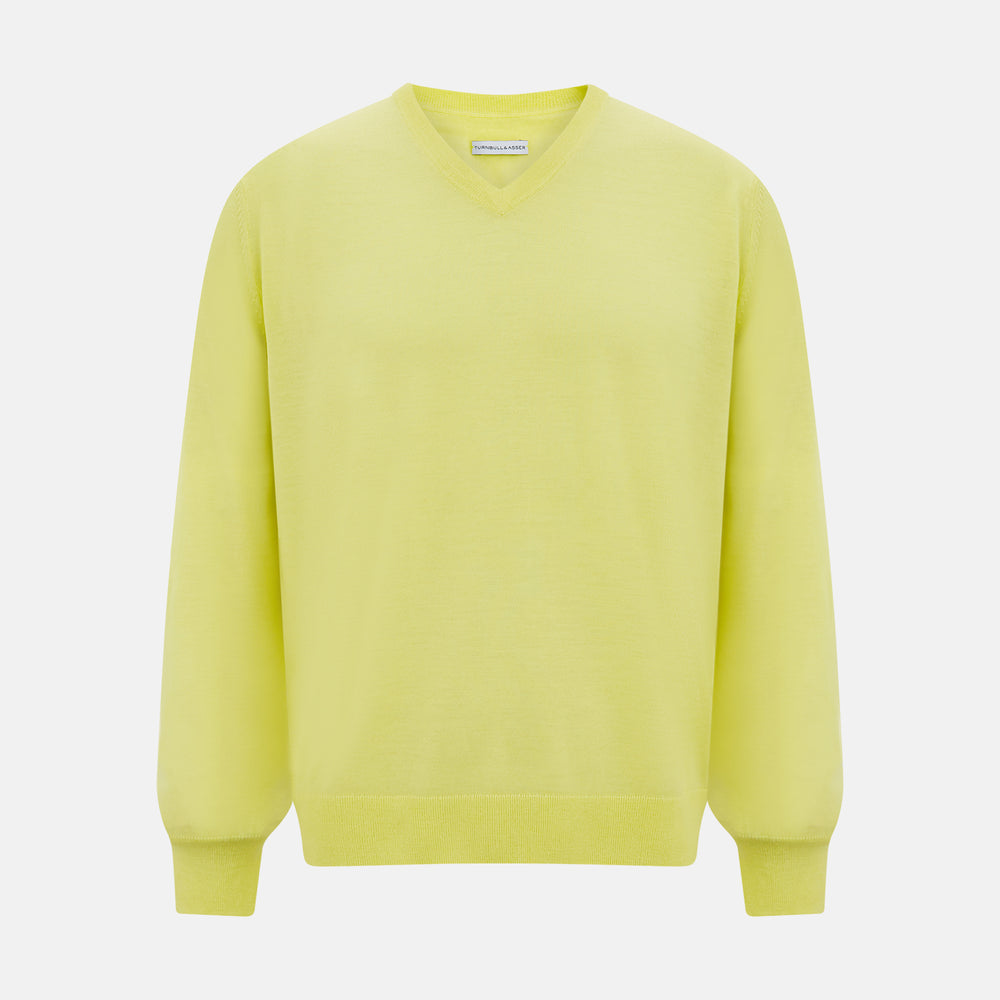 The Turnbull & Asser Bright Yellow Cashmere V-neck Jumper, a plain long-sleeved knitwear sweater, is showcased against a white background.