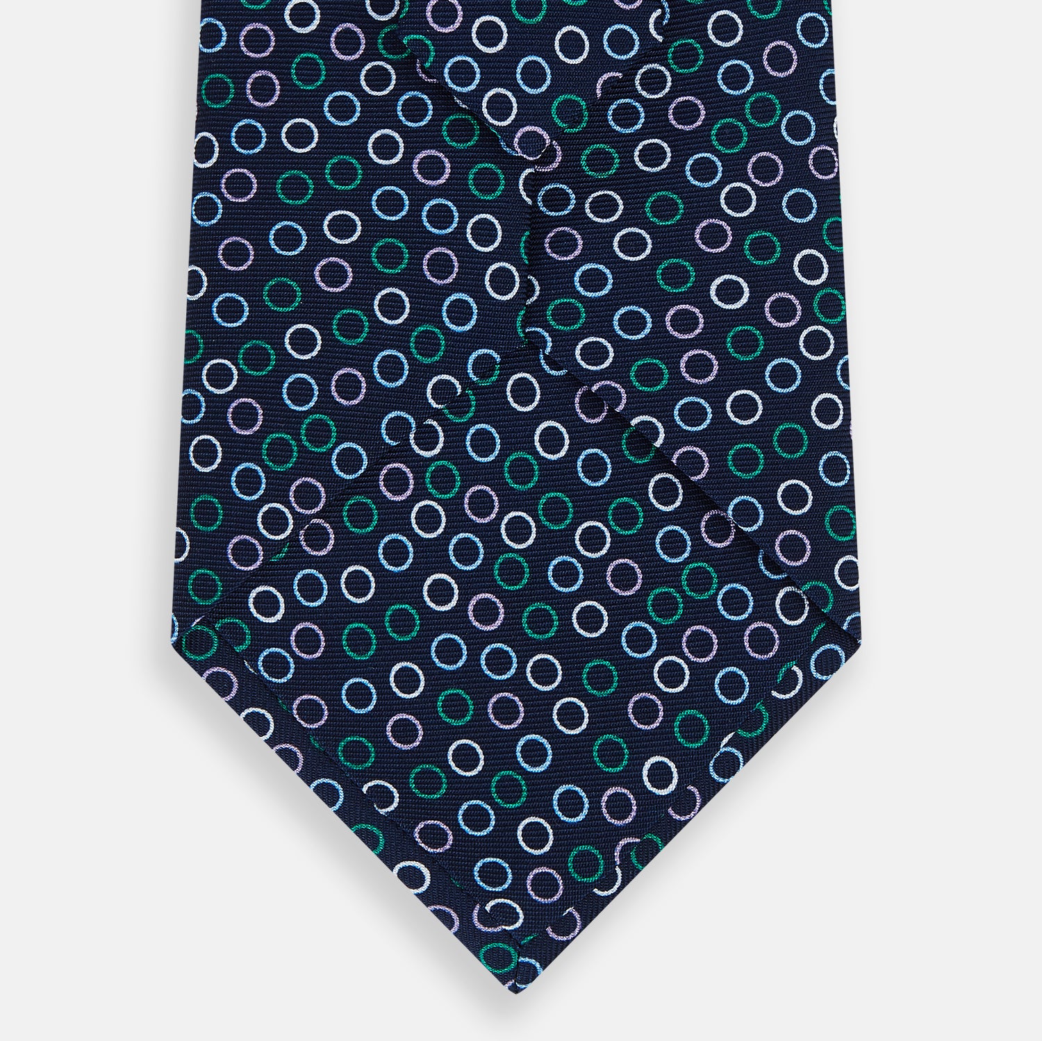 View 3 of product The Turnbull & Asser Green and Lilac Dark Navy Silk Tie features a pattern of small overlapping circles in green, blue, and lavender—an elegant formal accessory.