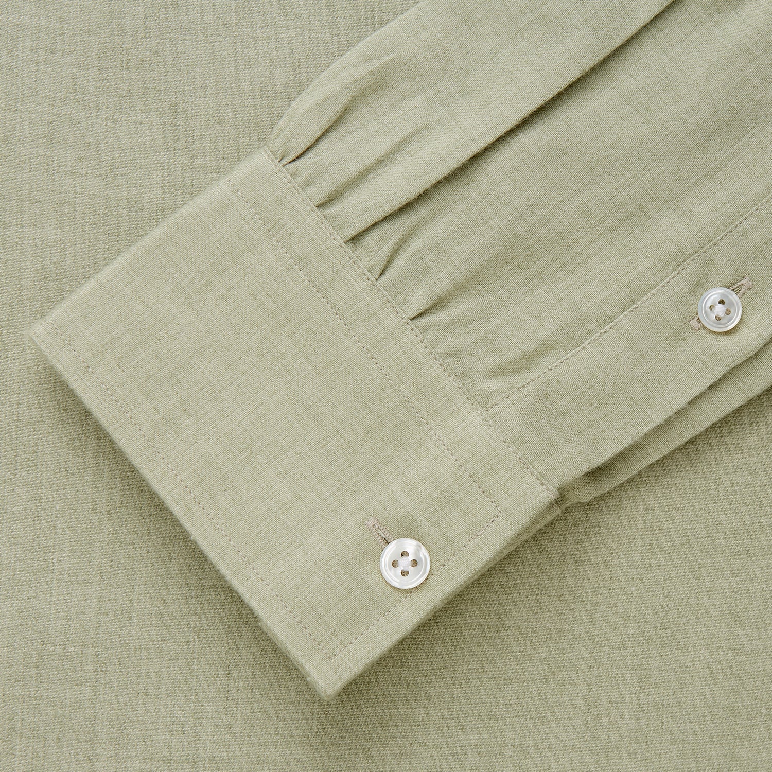 View 4 of product The Turnbull & Asser Soft Green Cashmerello Weekend Fit Finch Shirt features a Derby collar, long sleeves, chest pocket, white buttons, and cuffs. Laid flat on a white background.
