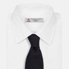 View 2 of product The Turnbull & Asser Midnight Blue Knitted Tie, elegantly textured and displayed on a white background, is a versatile addition to any gentleman's wardrobe.