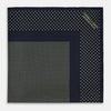 View 3 of product The Turnbull & Asser Navy and Gold Silk Pocket Square is handmade, featuring small gold polka dots on navy with a solid border, displayed neatly folded with one corner turned up.