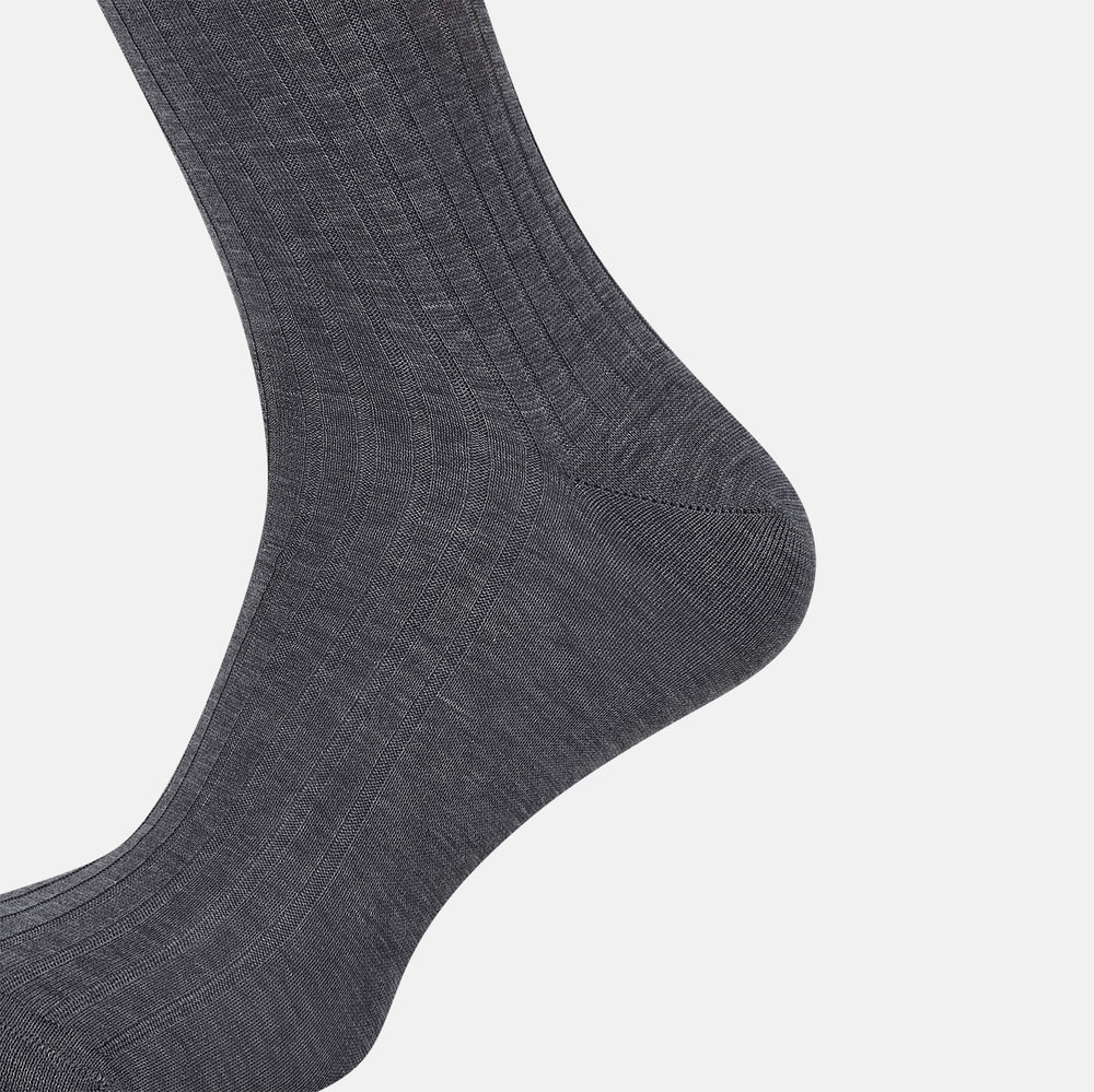 The Ash Long Sock by Turnbull & Asser is a single, knee-high sock in dark gray Egyptian cotton with a ribbed texture, displayed upright against a plain white background.