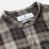 View 2 of product The Brown Multi Check Linen Weekend Fit Unwin Shirt by Turnbull & Asser features a beige, brown, and black plaid pattern, stand collar, button-up front, long sleeves, and two buttoned chest pockets.