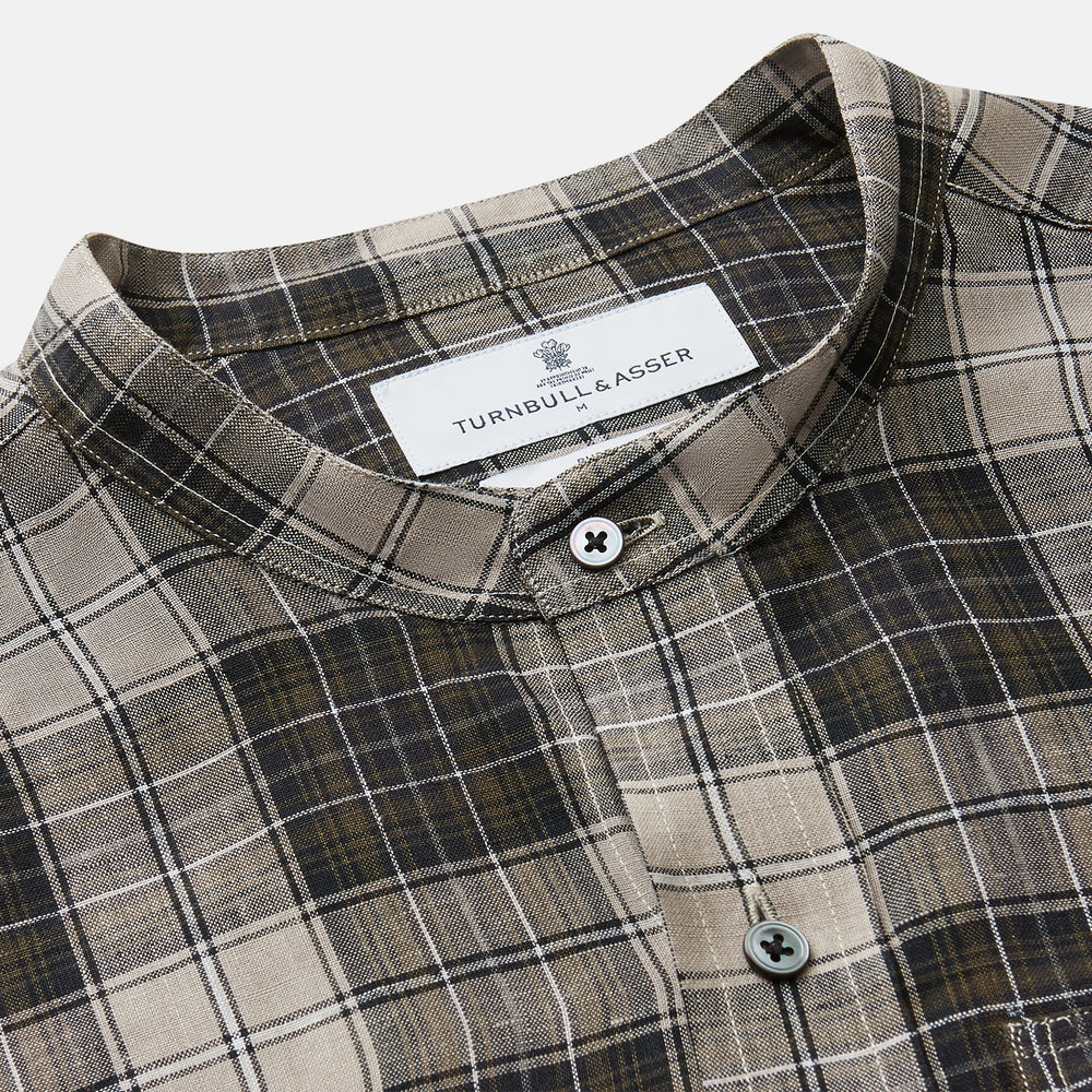The Brown Multi Check Linen Weekend Fit Unwin Shirt by Turnbull & Asser features a beige, brown, and black plaid pattern, stand collar, button-up front, long sleeves, and two buttoned chest pockets.