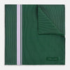 View 1 of product The Forest Green and Lilac Stripe Silk Pocket Square by Turnbull & Asser features thin white pinstripes, a bold light purple vertical stripe, and a visible branded label for classic British elegance. One corner is neatly folded over.