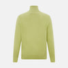 View 3 of product The Turnbull & Asser Melon Green Half-Zip Cashmere Jumper features long sleeves, a high collar, and half-zip front—ideal knitwear for layering. Shown on a plain white background.