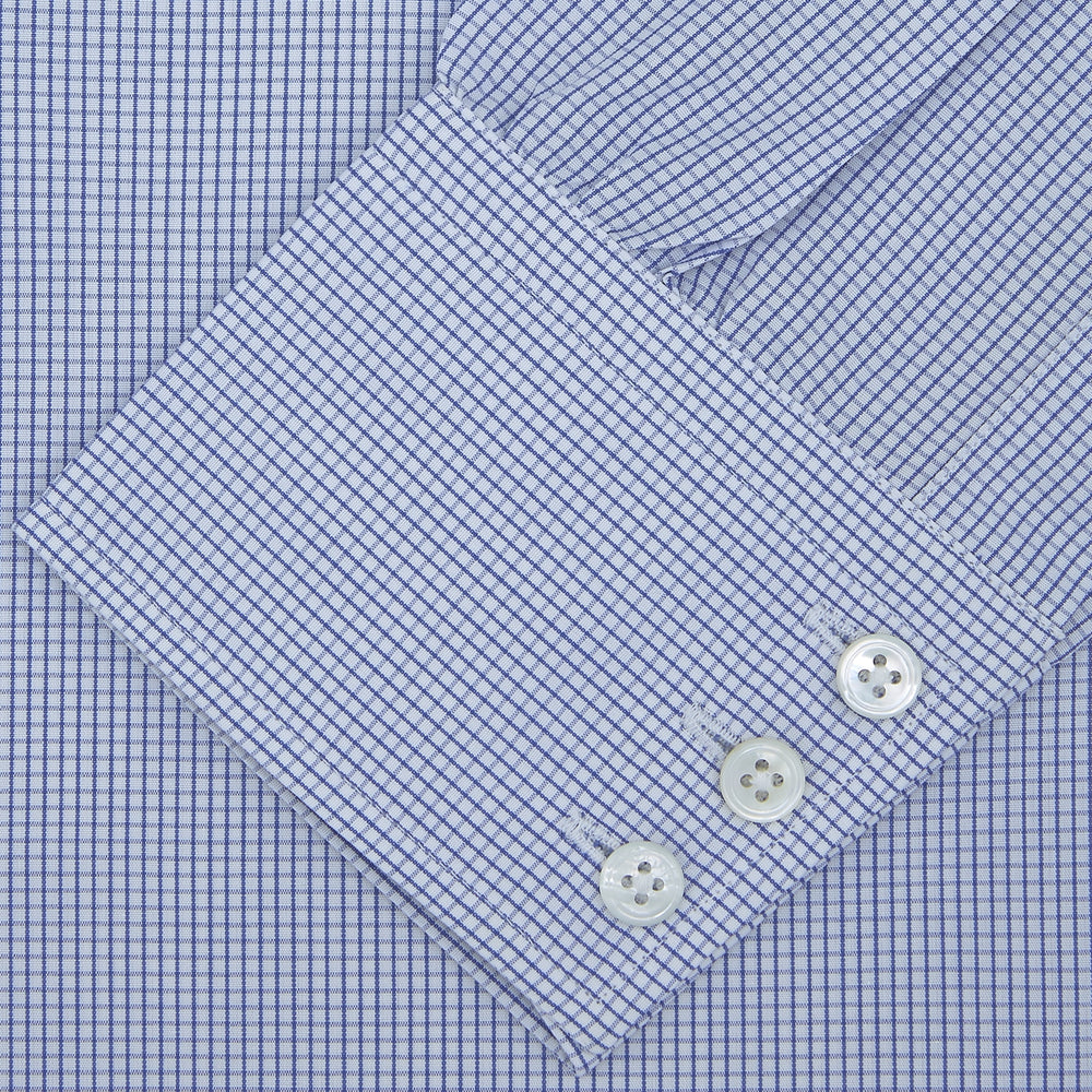 The Turnbull & Asser Blue Grid Check Shirt with Regent Collar and 3-Button Cuffs features white buttons and is neatly folded on a white background.