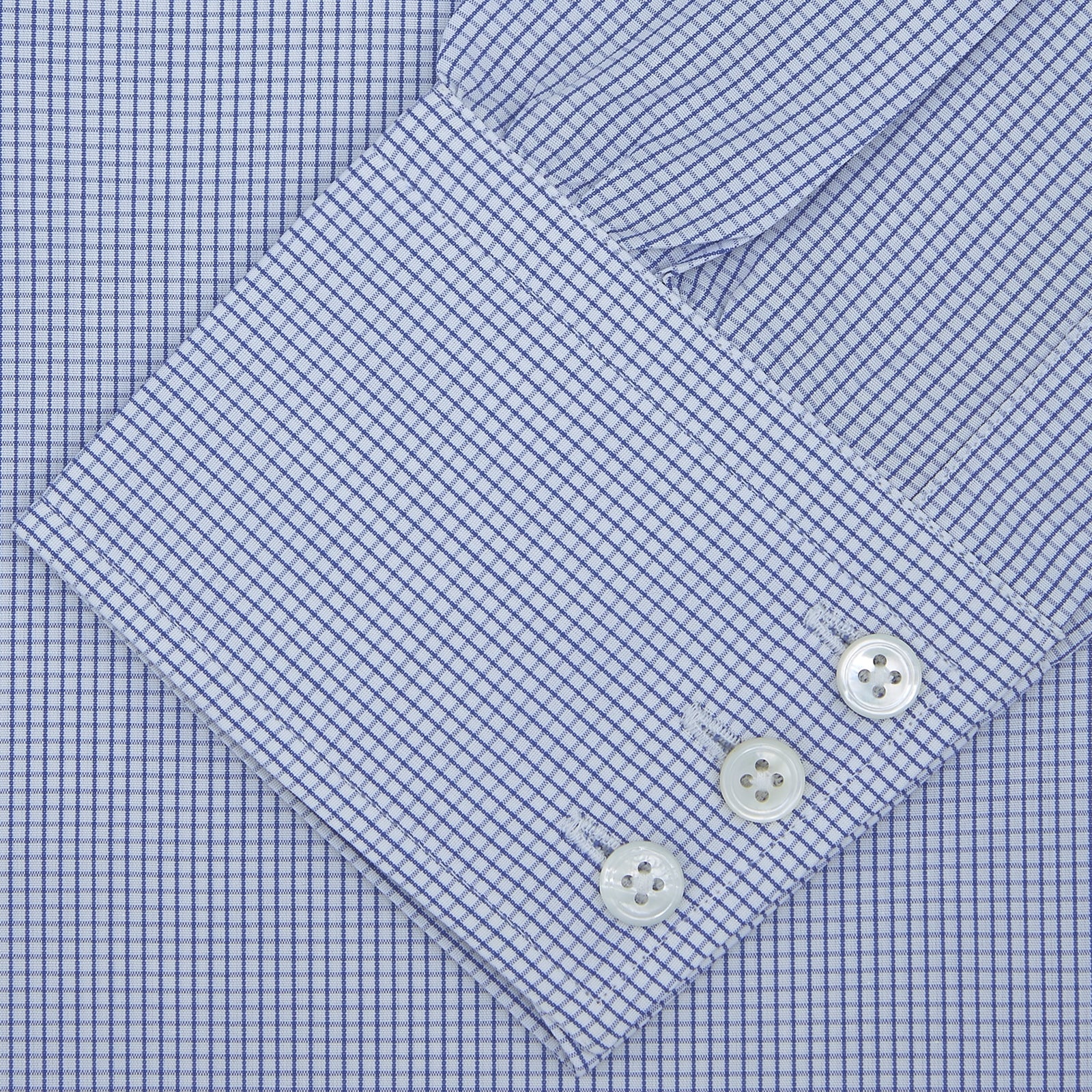 View 2 of product The Turnbull & Asser Blue Grid Check Shirt with Regent Collar and 3-Button Cuffs features white buttons and is neatly folded on a white background.
