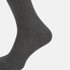 View 4 of product A single Grey Organic Cotton Mid-Length Sock by Turnbull & Asser is shown upright on a white background, featuring a ribbed texture and reinforced cuff.