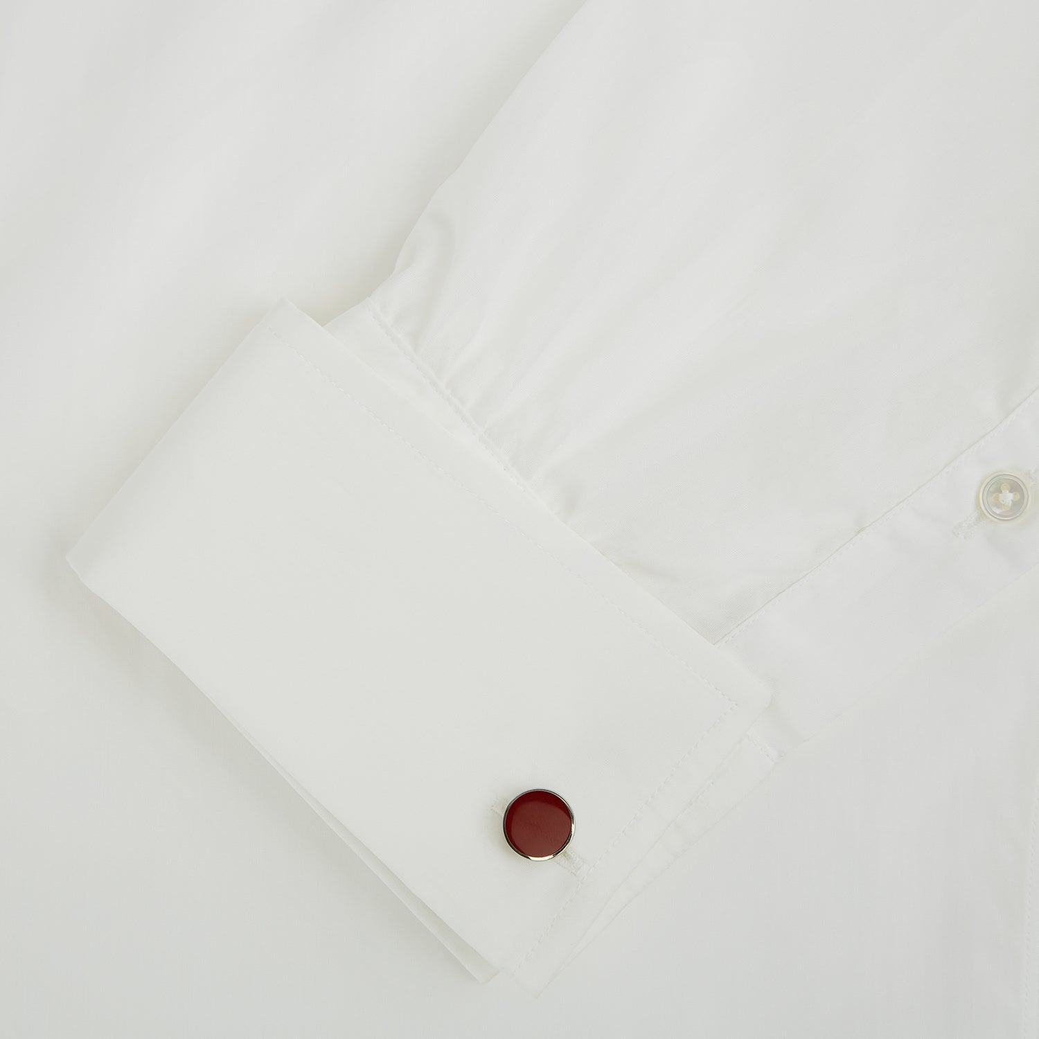 View 3 of product Turnbull & Asser's Red Circle Cufflinks feature round sterling silver with bold red enamel centers, offering a refined accessory for gentlemen, shown on a white background.