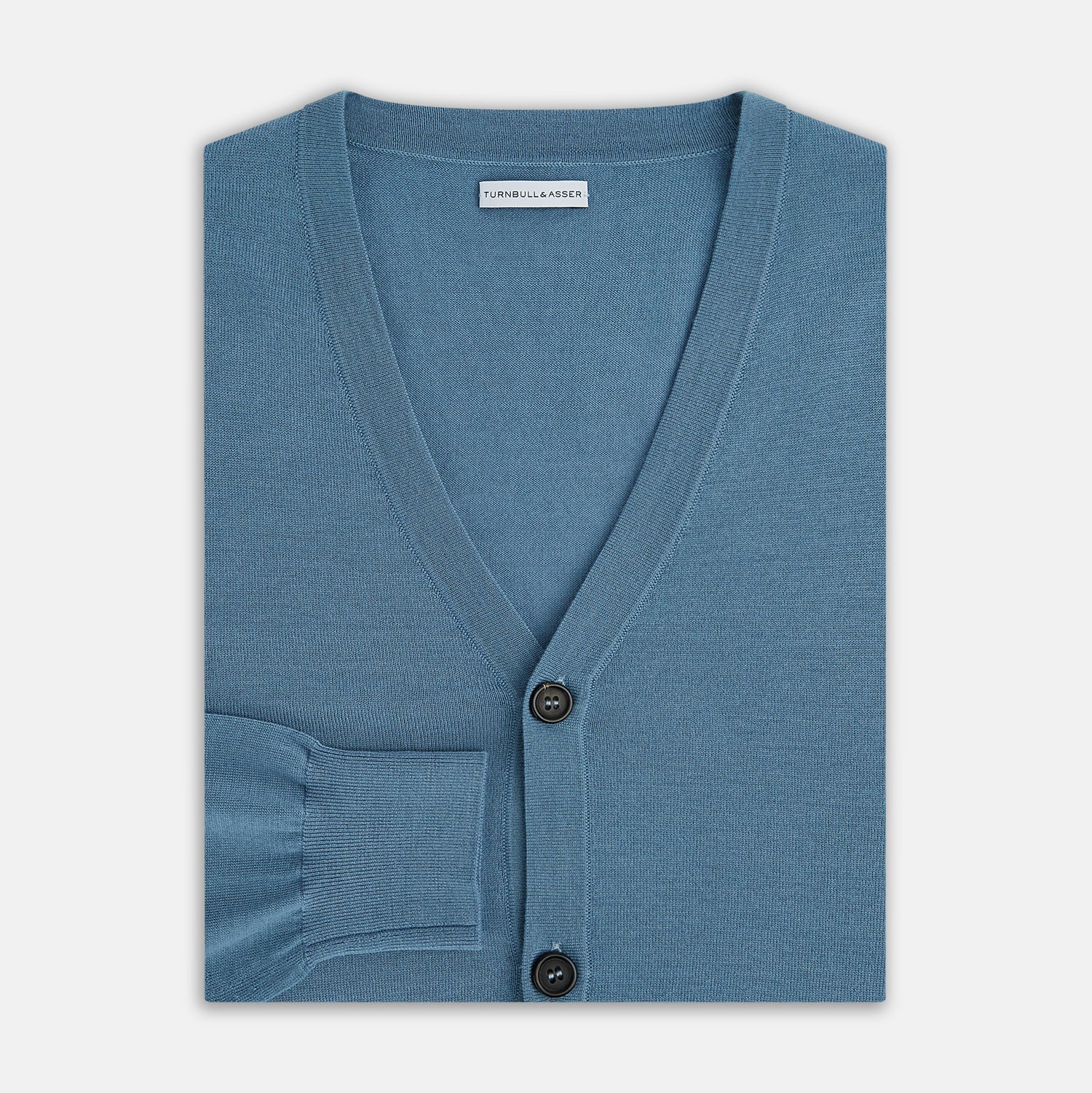 View 4 of product The Turnbull & Asser Pale Blue Fine Merino V-Neck Cardigan features long sleeves and five black buttons, showcased on a plain white background.