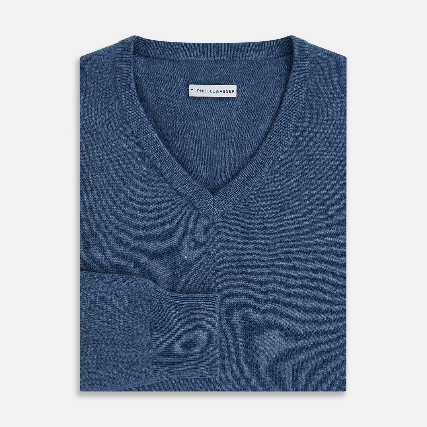 View 4 of product Turnbull & Asser’s Pacific Blue Cashmere V-Neck Jumper features ribbed cuffs, hem, and neckline, shown on a white background.