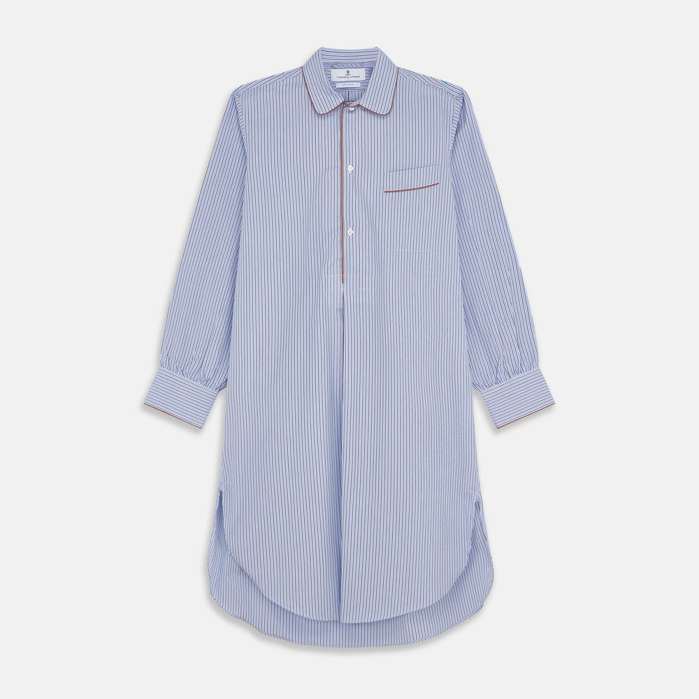 The Blue and Navy Halo Stripe Cotton Sussex Nightshirt by Turnbull & Asser features long sleeves, a collar, button-down front, chest pocket, curved hem, and brown piping for a classic luxury sleepwear style.
