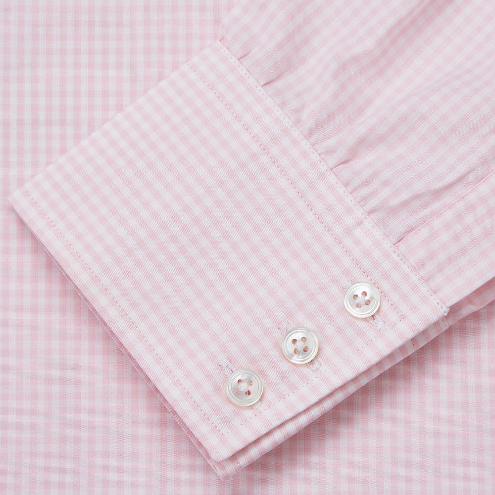 The Pink Windowpane Check Mayfair Shirt by Turnbull & Asser is crafted in light pink organic cotton with a subtle windowpane check, button-down front, and pointed collar, displayed flat on a white background.