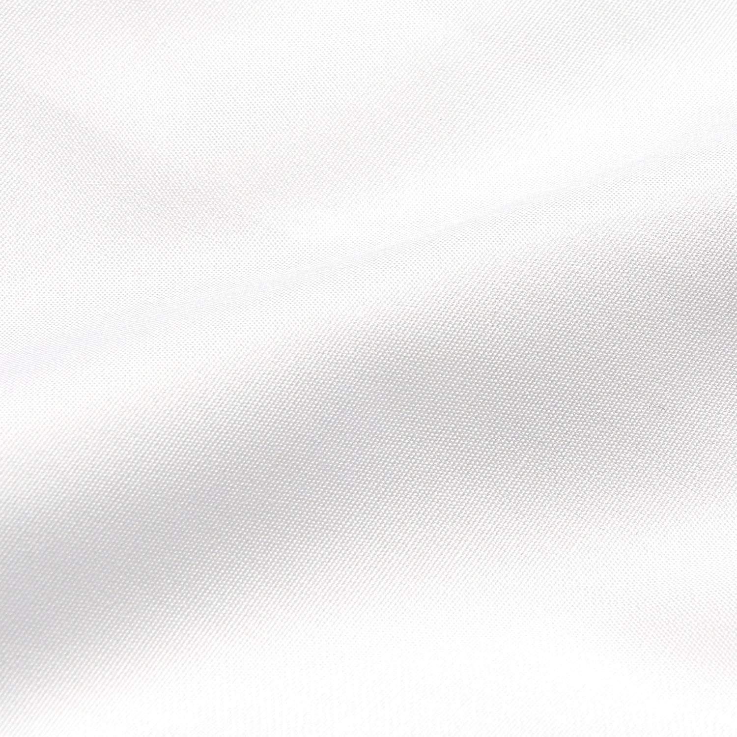 View 11 of product A woman stands in profile, looking down with hands in her pockets, wearing the Turnbull & Asser Turnbull and The Deck White Cotton Expressionist Shirt, paired with high-waisted black-and-white houndstooth pants.