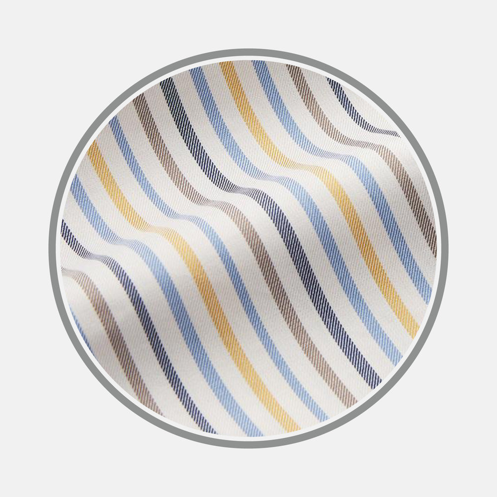 A close-up of Turnbull & Asser's Yellow Multi Stripe Cotton Fabric, featuring diagonal light blue, yellow, beige, and gray stripes on white. Shown in a circular frame, the fabric displays gentle waves and subtle texture.