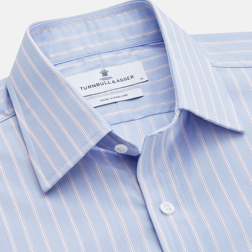 The Turnbull & Asser Blue Multi Stripe Cotton Regular Fit Whitby Shirt features white vertical stripes, long sleeves, button-down front, pointed collar, and buttoned cuffs, shown laid flat on a white background.
