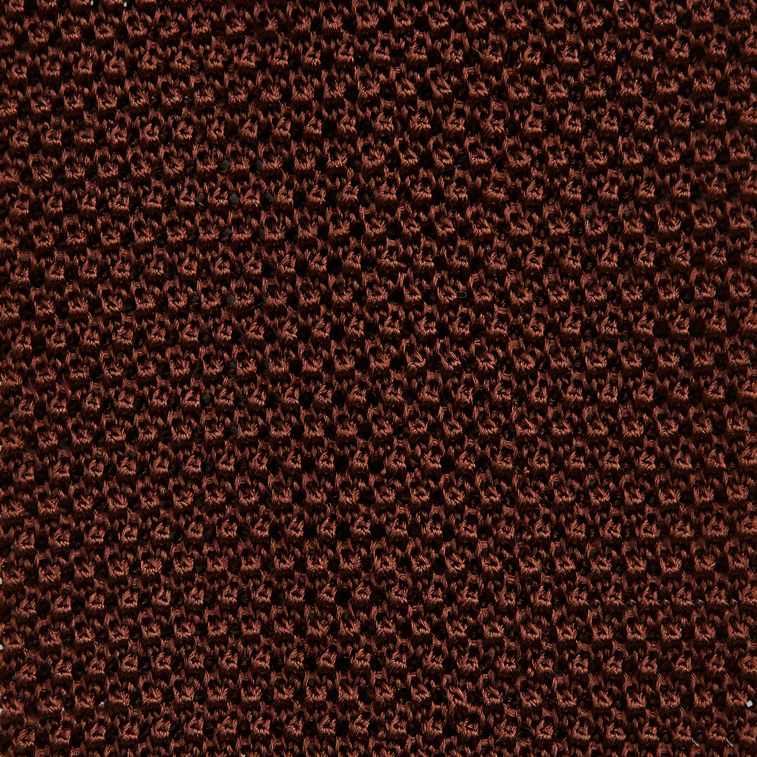 View 3 of product The Turnbull & Asser KNITTED BROWN SILK PLAIN TIE—a stylish, textured accessory—appears rolled up on a white background, perfect for elevating smart outfits.