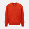 View 1 of product The Turnbull & Asser Red Orange Cashmere V-neck Jumper features long sleeves, ribbed cuffs and hem, displayed on a plain white background—a stylish knitwear essential for any wardrobe.