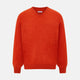 The Turnbull & Asser Red Orange Cashmere V-neck Jumper features long sleeves, ribbed cuffs and hem, displayed on a plain white background—a stylish knitwear essential for any wardrobe.