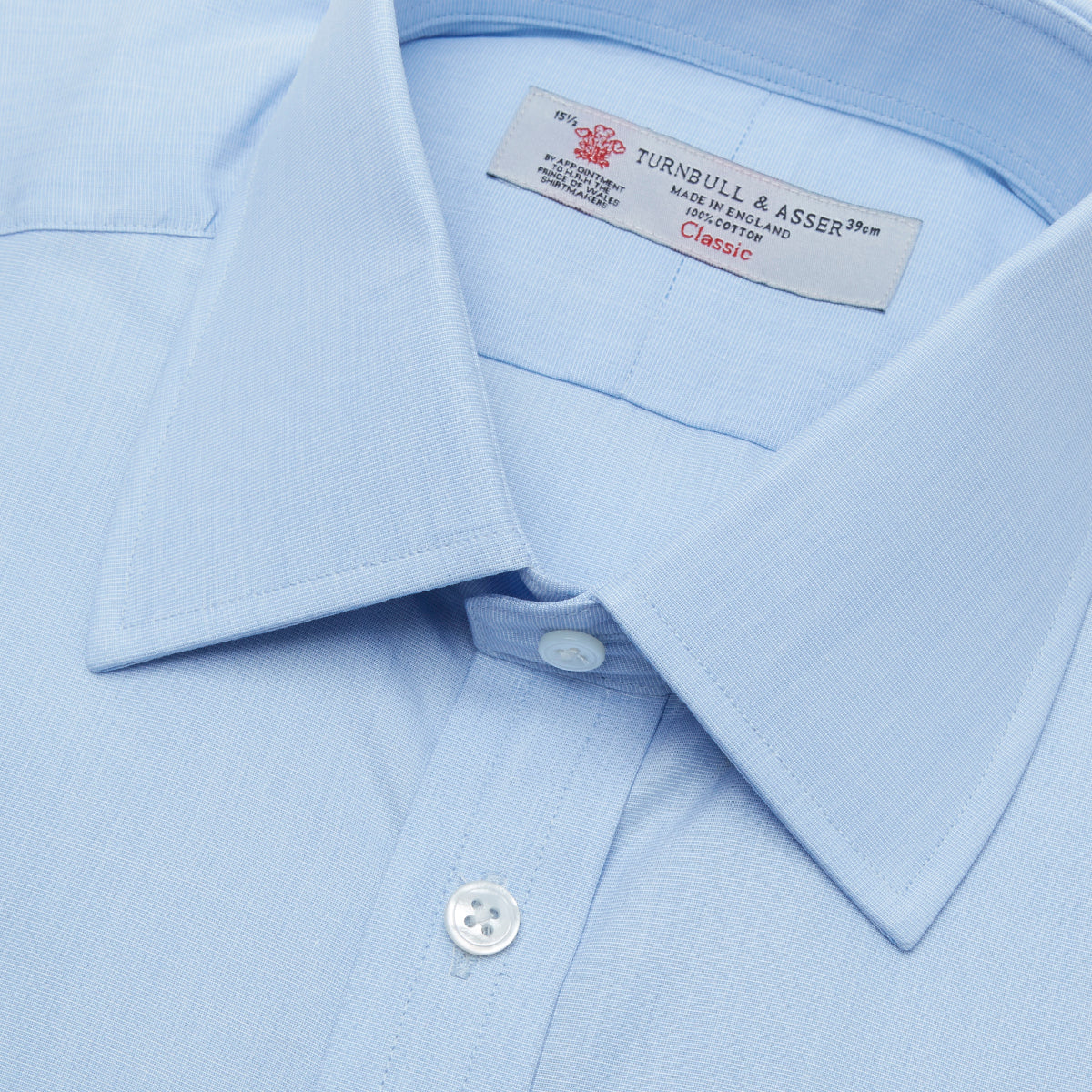 View 5 of product A Grey Cashmere Blend Shirt by Turnbull & Asser with a T&A collar and 3-button cuffs is neatly folded, showing its label, on a plain white background.