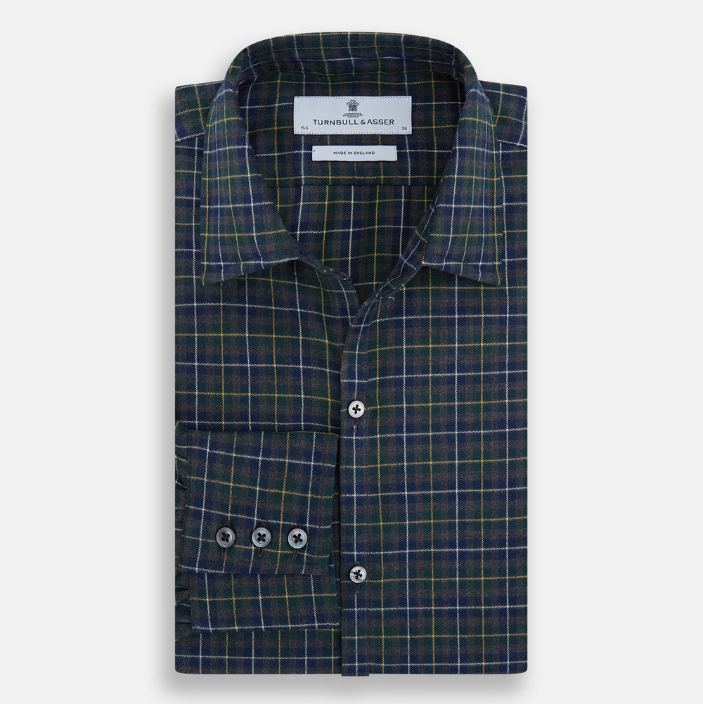 The Turnbull & Asser Navy and Khaki Tartan Windsor Shirt features a long-sleeve button-up design with a Windsor collar and buttoned cuffs, showcasing British craftsmanship in a classic tartan pattern.