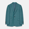 View 2 of product A man with short brown hair and a neutral expression stands against a plain background, wearing a Teal Linen Barrington Blazer by Turnbull & Asser, a light pink dress shirt, white trousers, brown loafers, and a patterned pocket square.