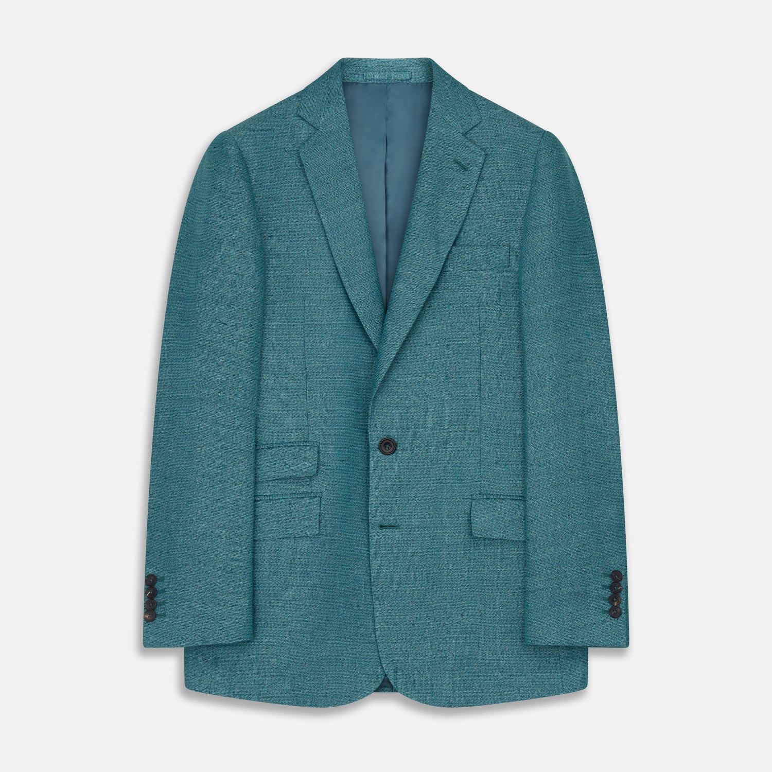 View 2 of product A man with short brown hair and a neutral expression stands against a plain background, wearing a Teal Linen Barrington Blazer by Turnbull & Asser, a light pink dress shirt, white trousers, brown loafers, and a patterned pocket square.
