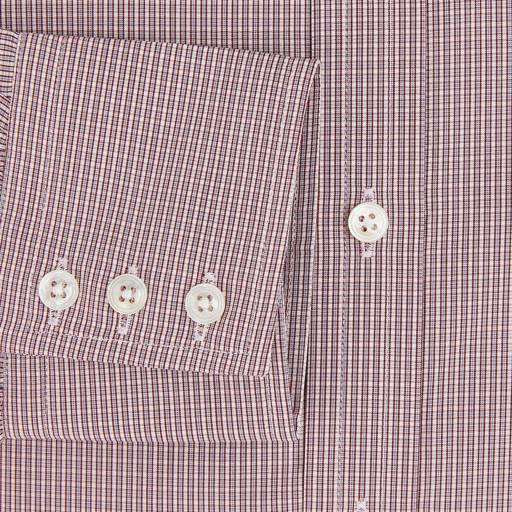 The Turnbull & Asser Burgundy Micro Shadow Check Mayfair Shirt features long sleeves, a classic collar, and white buttons. In light red and white shades, this button-up is perfect for formal wear and is shown laid flat against a white background.