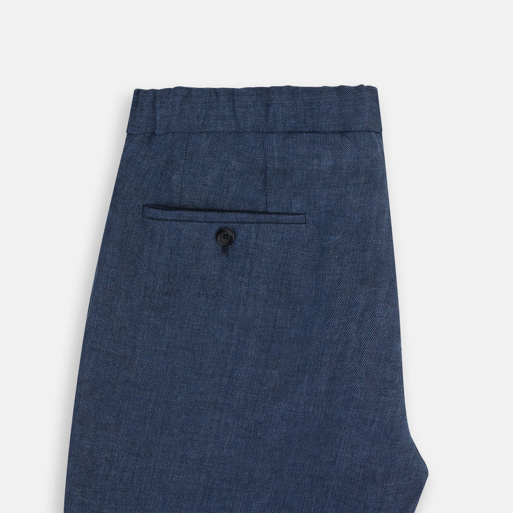 Turnbull & Asser Denim Blue Linen Herringbone Miles Trousers with a straight-leg fit, elasticated waist, and drawstring tie, shown against a plain white background.