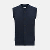 View 1 of product The Turnbull & Asser Navy Melange Cashmere Sleeveless Cardigan features a V-neck, button-down front, ribbed hem and armholes, and two front pockets—ideal for layering. Shown against a plain white background.