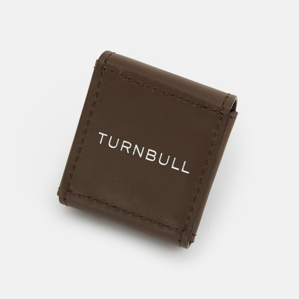 Turnbull & Asser’s Dark Chocolate Leather Cufflinks feature square Italian leather with stitched edges and braided links, perfect for men’s accessories, shown here on a white background.