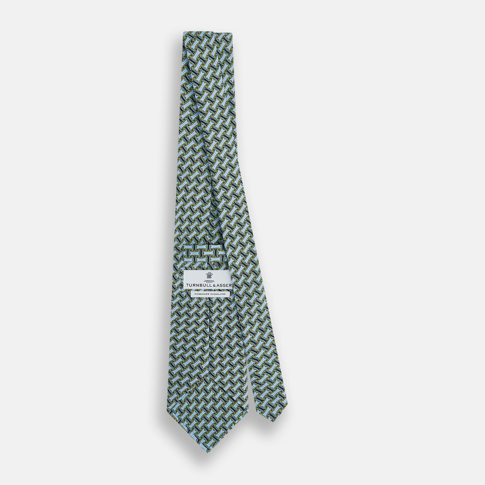 The Turnbull & Asser Light Blue and Chartreuse Lemon Weave Patterned Silk Tie, crafted from fine English silk, features a geometric design in blue and green tones, displayed on a plain white background.