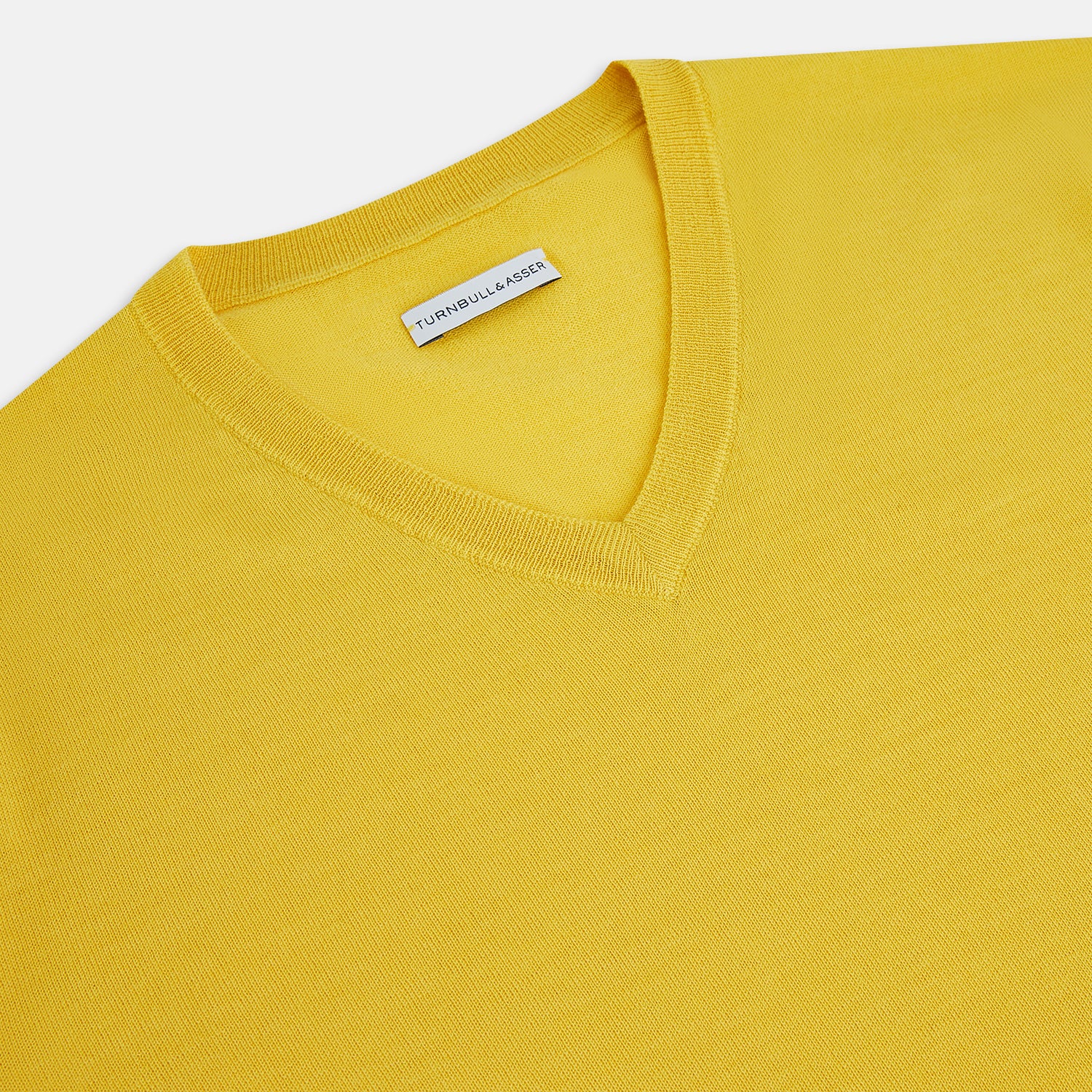 View 2 of product The Turnbull & Asser Canary Yellow Fine Merino V-Neck Jumper, crafted from soft knitwear, features long sleeves and is displayed on a white background.