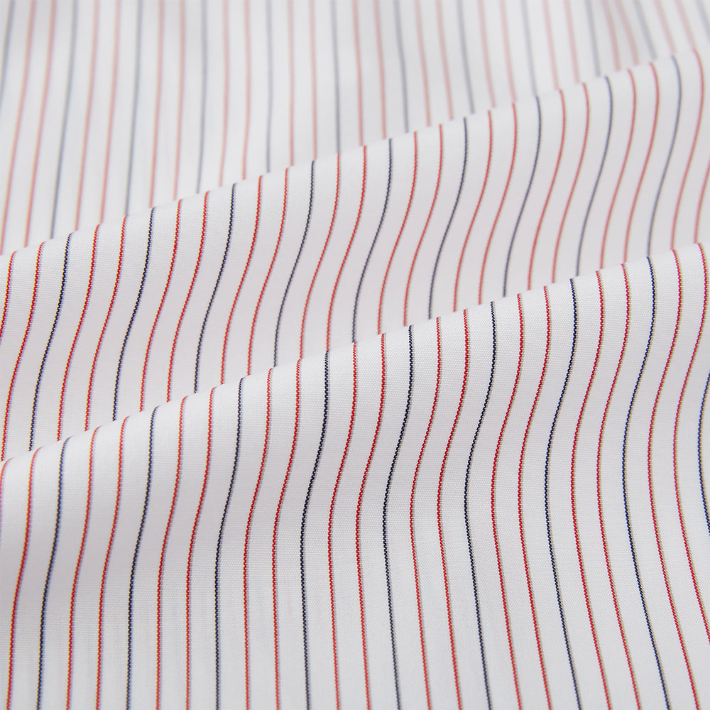 The Turnbull & Asser Red and Blue Ticking Stripe Westminster Shirt features long sleeves, a button-up front, pointed collar, and buttoned cuffs, highlighting British craftsmanship while laid flat on a white background.