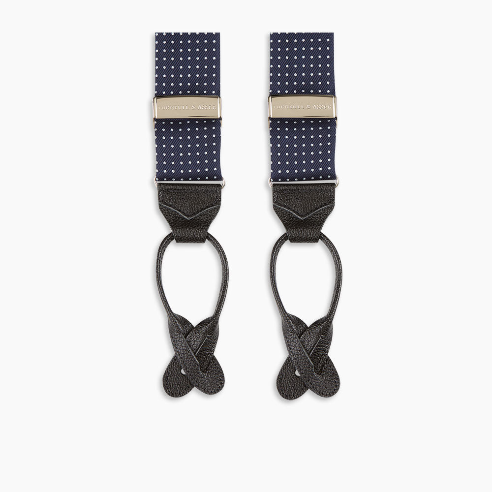 Turnbull & Asser Navy & White Small Spot Adjustable Silk Braces feature black leather loops and silver clasps—timeless accessories displayed on a white background.
