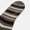 View 3 of product The Coffee Striped Merino Wool Long Socks by Turnbull & Asser feature knee-high length with horizontal brown, beige, and cream stripes, shown against a plain white background.