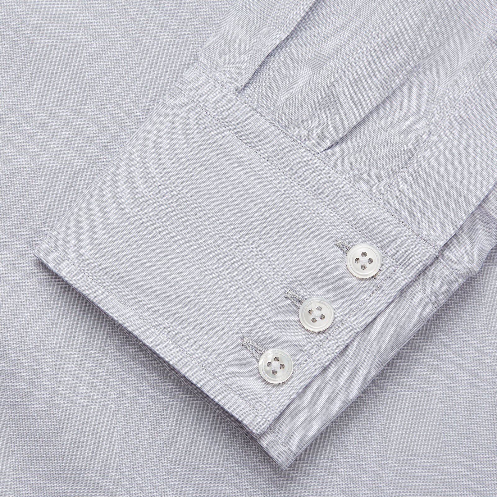 View 3 of product The Turnbull & Asser Faded Blue Block Check Cotton Regular Fit Mayfair Shirt, featuring long sleeves, a classic collar, and white buttons, is neatly laid flat on a white background.