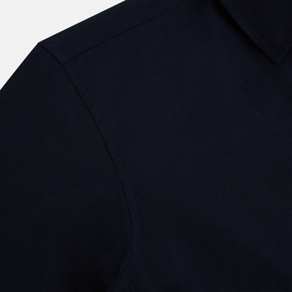 The NAVY BLUE WINDSOR SHIRT by Turnbull & Asser features long sleeves, a classic Windsor collar, white buttons, and buttoned cuffs—highlighting refined British craftsmanship against a plain white background.